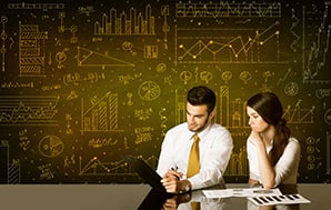 Business couple sitting at black table with hand drawn diagram background